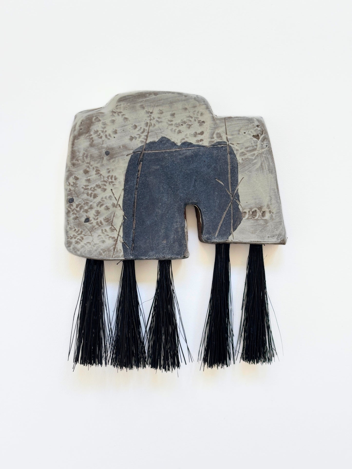 Artifact brush dusty black and white black fibers