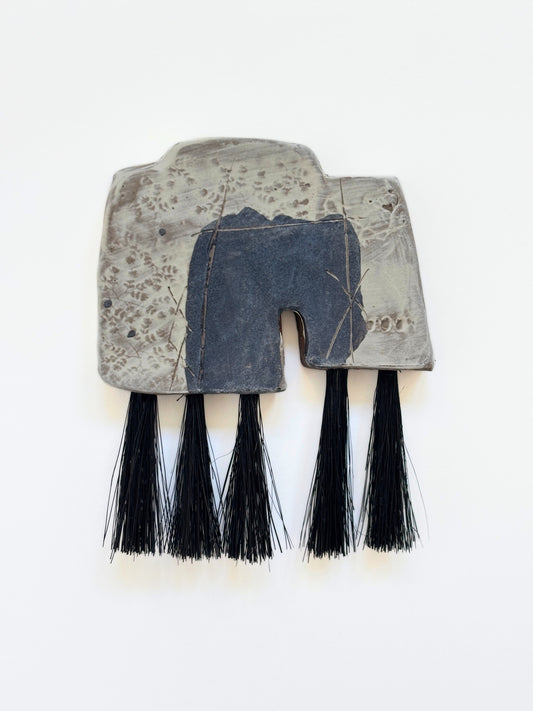 Artifact brush dusty black and white black fibers